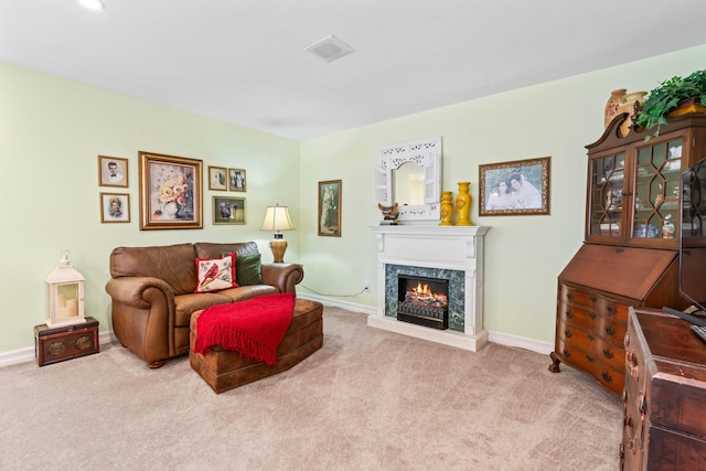 living room featuring carpet, a fireplace, and baseboards