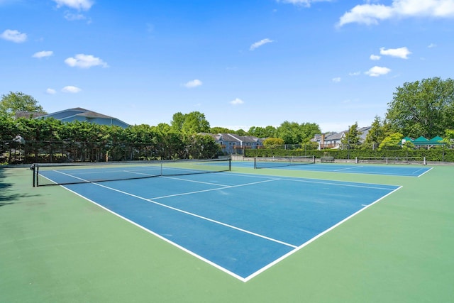 view of tennis court with fence