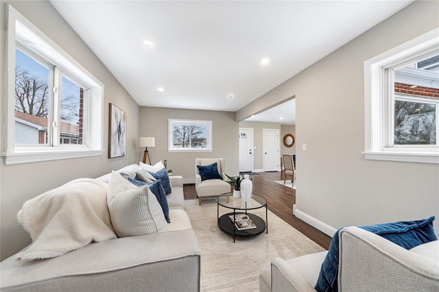 living area with light wood finished floors, baseboards, and recessed lighting