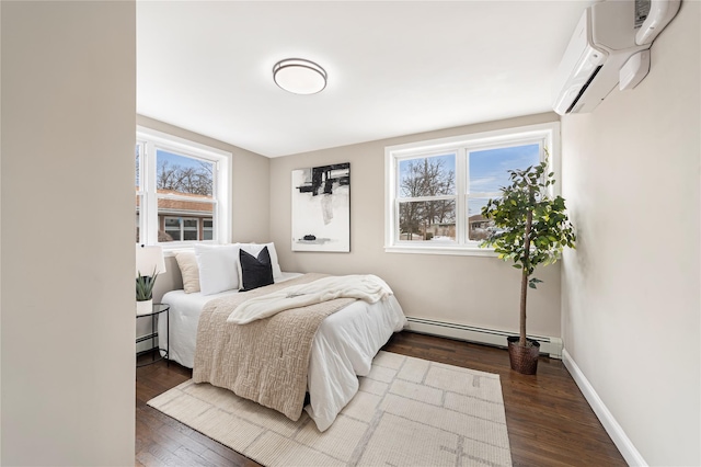 bedroom featuring dark wood-style flooring, a wall mounted air conditioner, baseboard heating, and multiple windows