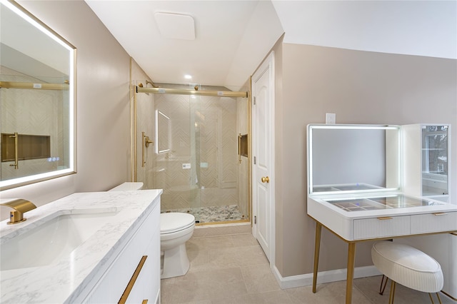 bathroom featuring a stall shower, baseboards, toilet, tile patterned flooring, and vanity