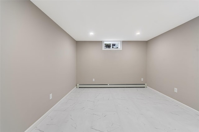 unfurnished room with marble finish floor, baseboards, and baseboard heating