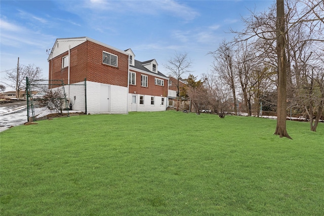 view of yard featuring a garage and fence