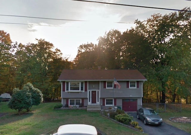 bi-level home featuring a front yard and a garage