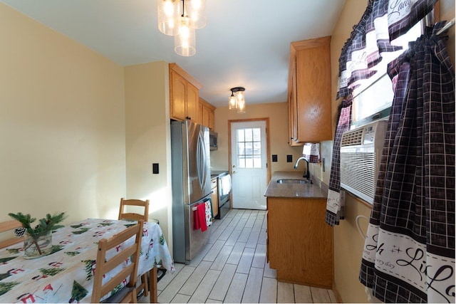 203 Front Ave, Brentwood, NY 11717 - kitchen featuring appliances with stainless steel finishes, wood tiled floor, light countertops, and a sink