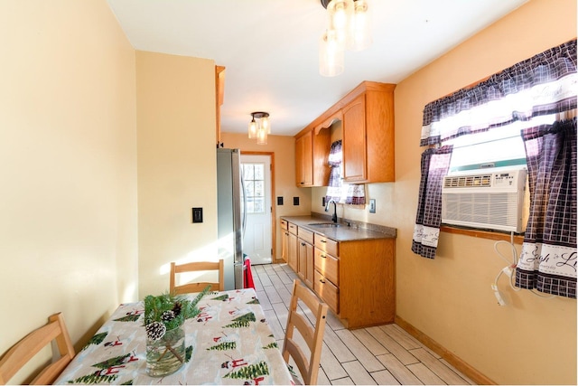 203 Front Ave, Brentwood, NY 11717 - kitchen featuring cooling unit, a sink, baseboards, freestanding refrigerator, and dark countertops