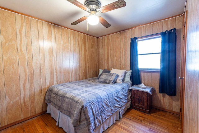 203 Front Ave, Brentwood, NY 11717 - bedroom with light wood finished floors, ceiling fan, and wooden walls