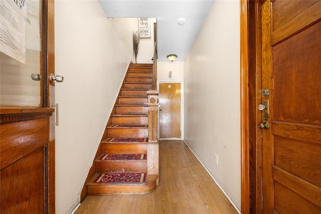 staircase featuring wood finished floors