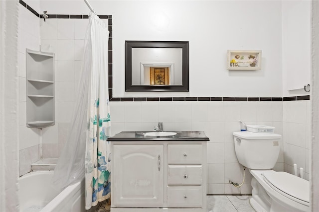 full bath with toilet, vanity, shower / bath combo with shower curtain, and tile walls