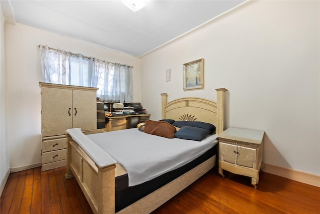 bedroom featuring dark wood-type flooring and baseboards