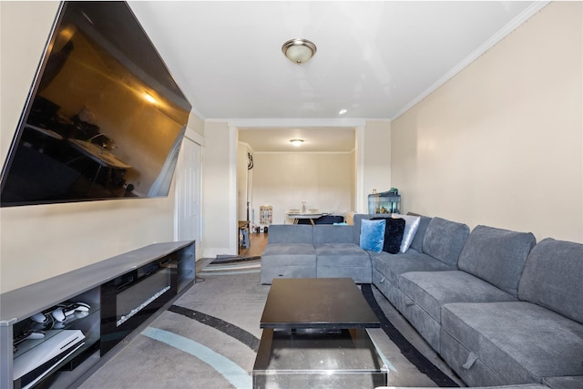 carpeted living area featuring ornamental molding and baseboards