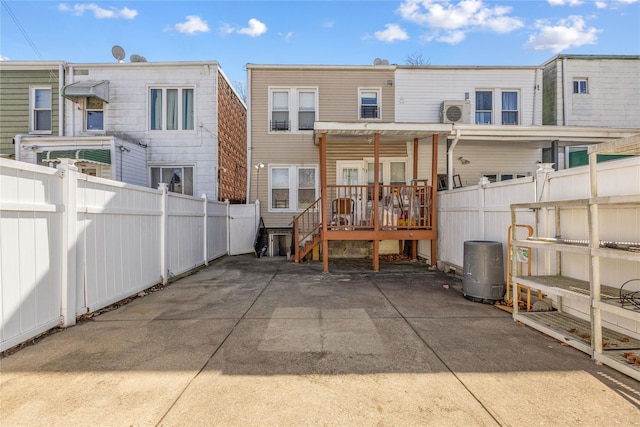 rear view of house featuring a fenced backyard and a patio