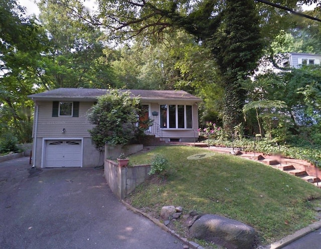 view of front of house with a garage and a front yard