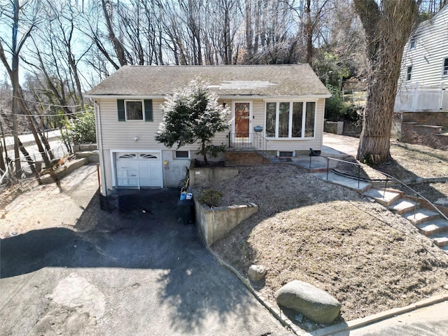 view of front of property featuring driveway and an attached garage