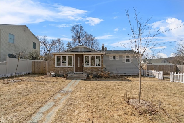 view of front of property featuring fence, a chimney, and crawl space