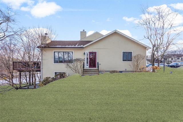 view of front of house featuring entry steps, a chimney, and a front yard