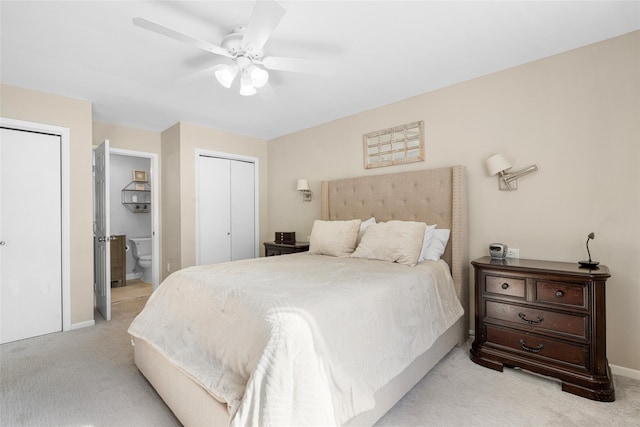 bedroom with light carpet, ceiling fan, baseboards, and ensuite bathroom