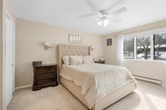 bedroom featuring light carpet, baseboards, a baseboard heating unit, and ceiling fan