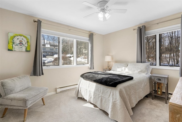 bedroom with a ceiling fan, baseboards, baseboard heating, and carpet flooring