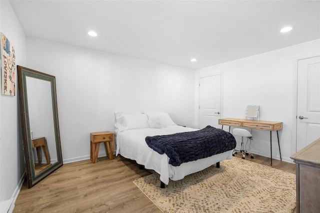 bedroom featuring light wood-type flooring, baseboards, and recessed lighting