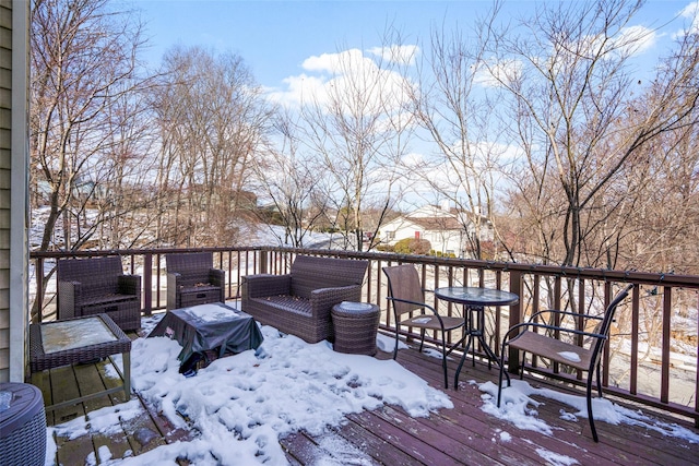 snow covered deck with an outdoor living space