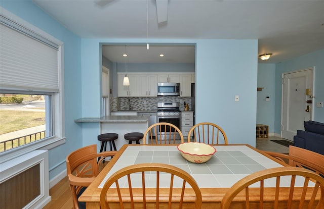 dining room featuring baseboards and radiator heating unit