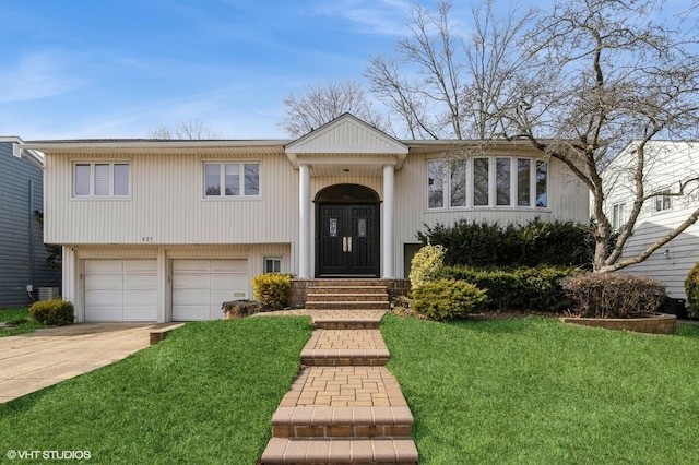 view of front of house featuring an attached garage, concrete driveway, a front yard, and entry steps