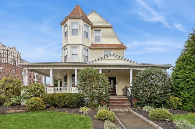 victorian-style house featuring covered porch