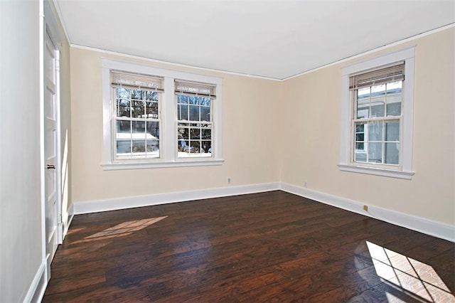 empty room with dark wood-style floors and baseboards