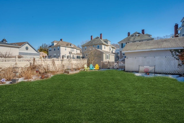 view of yard with a residential view and fence