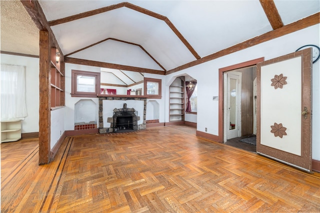 unfurnished living room with high vaulted ceiling, built in shelves, a fireplace, and baseboards