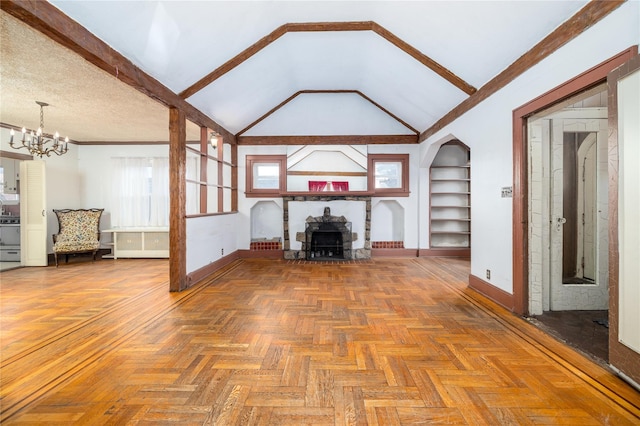 unfurnished living room with built in shelves, a notable chandelier, lofted ceiling, a textured ceiling, and baseboards