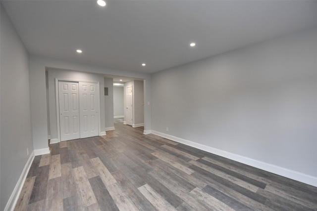 unfurnished bedroom with a closet and dark hardwood / wood-style flooring