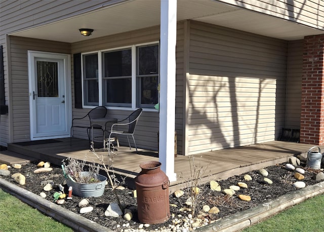 view of exterior entry with brick siding