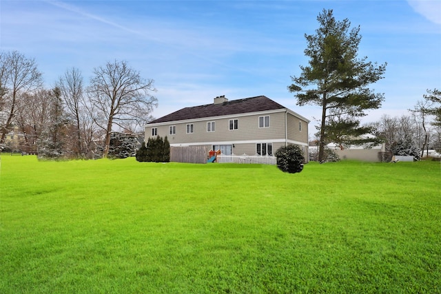 rear view of property with a lawn