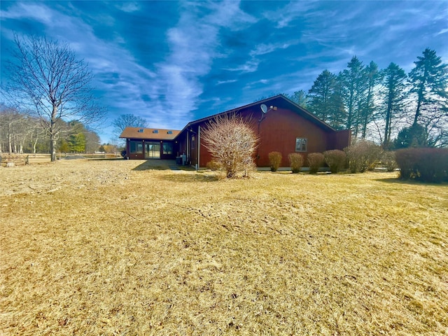 view of side of property with a lawn