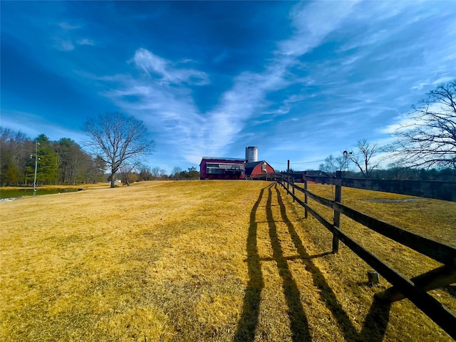 view of yard with a barn and fence