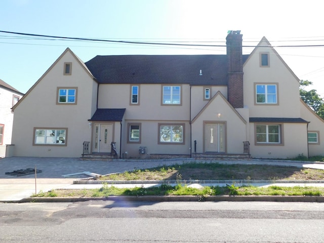 townhome / multi-family property with entry steps and stucco siding