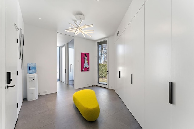 workout area featuring an inviting chandelier and visible vents