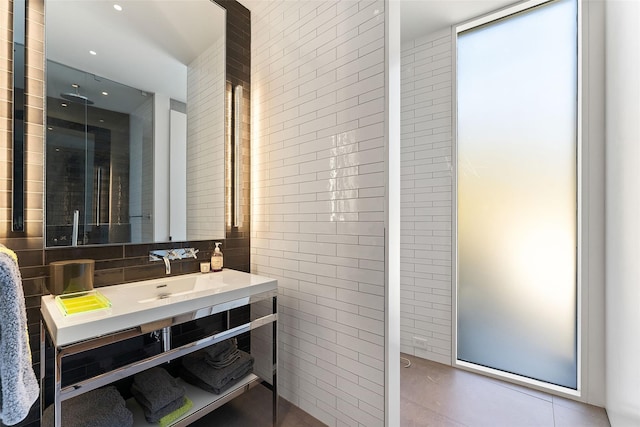 bathroom with vanity and tile walls