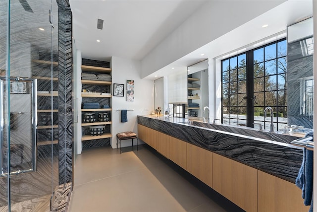 interior space featuring recessed lighting, visible vents, a stall shower, vanity, and concrete flooring