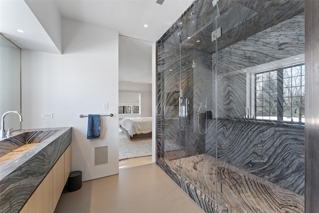 bathroom featuring a stall shower, recessed lighting, a sink, and ensuite bathroom