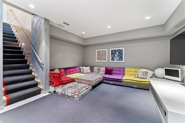 carpeted living area featuring stairs, visible vents, and recessed lighting