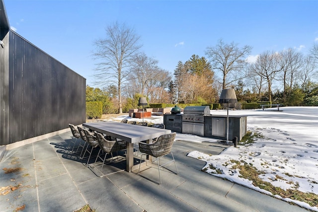 view of patio with exterior kitchen, outdoor dining space, and grilling area