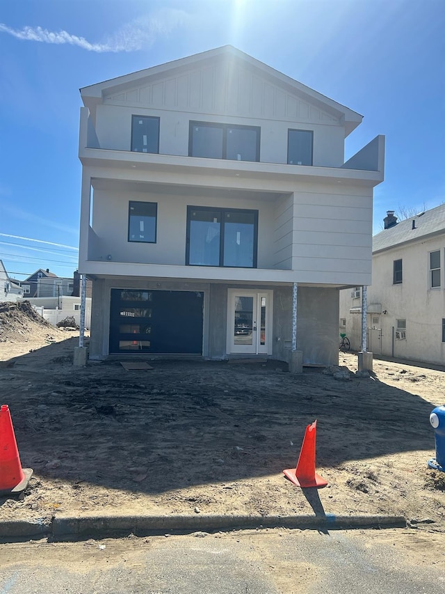 view of front of property featuring an attached garage, board and batten siding, and driveway