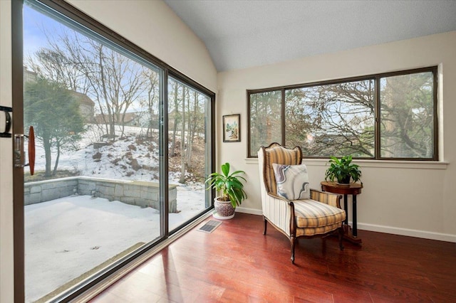 sunroom / solarium featuring lofted ceiling and visible vents