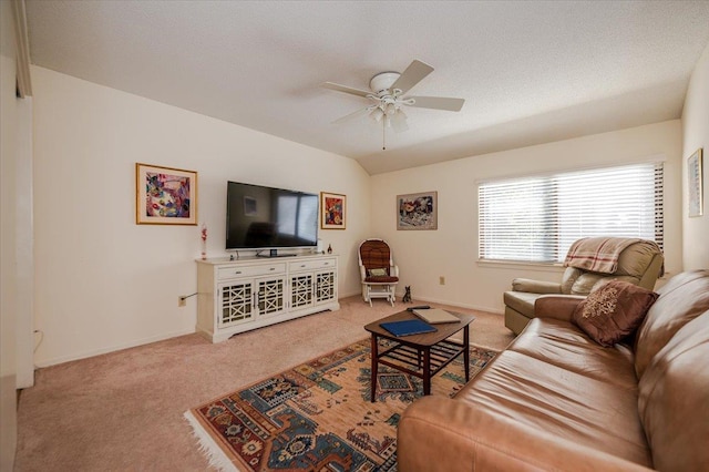 carpeted living area with vaulted ceiling, a textured ceiling, a ceiling fan, and baseboards