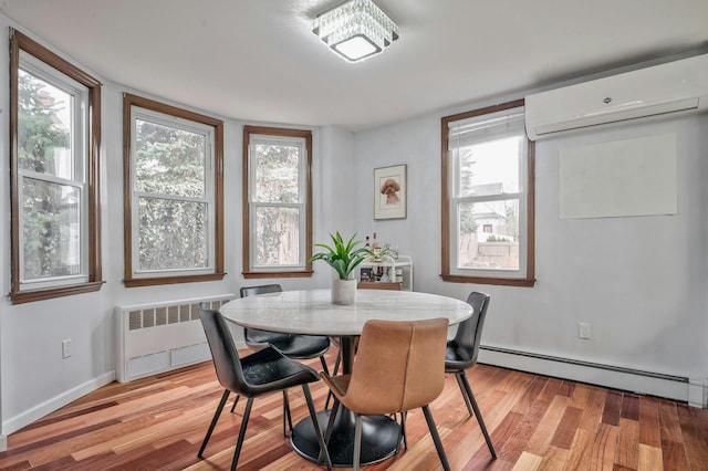 dining room featuring light wood-style flooring, baseboards, baseboard heating, radiator, and a wall mounted air conditioner