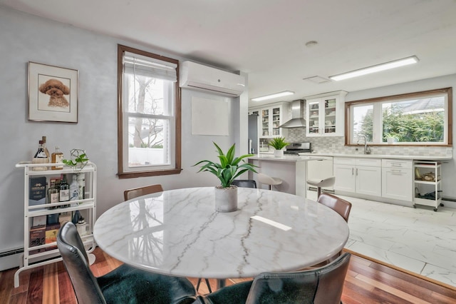 dining area with marble finish floor and a wall mounted AC