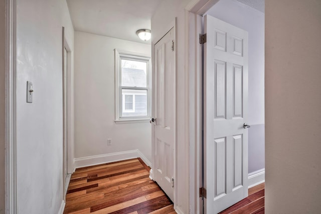 hall with wood finished floors and baseboards